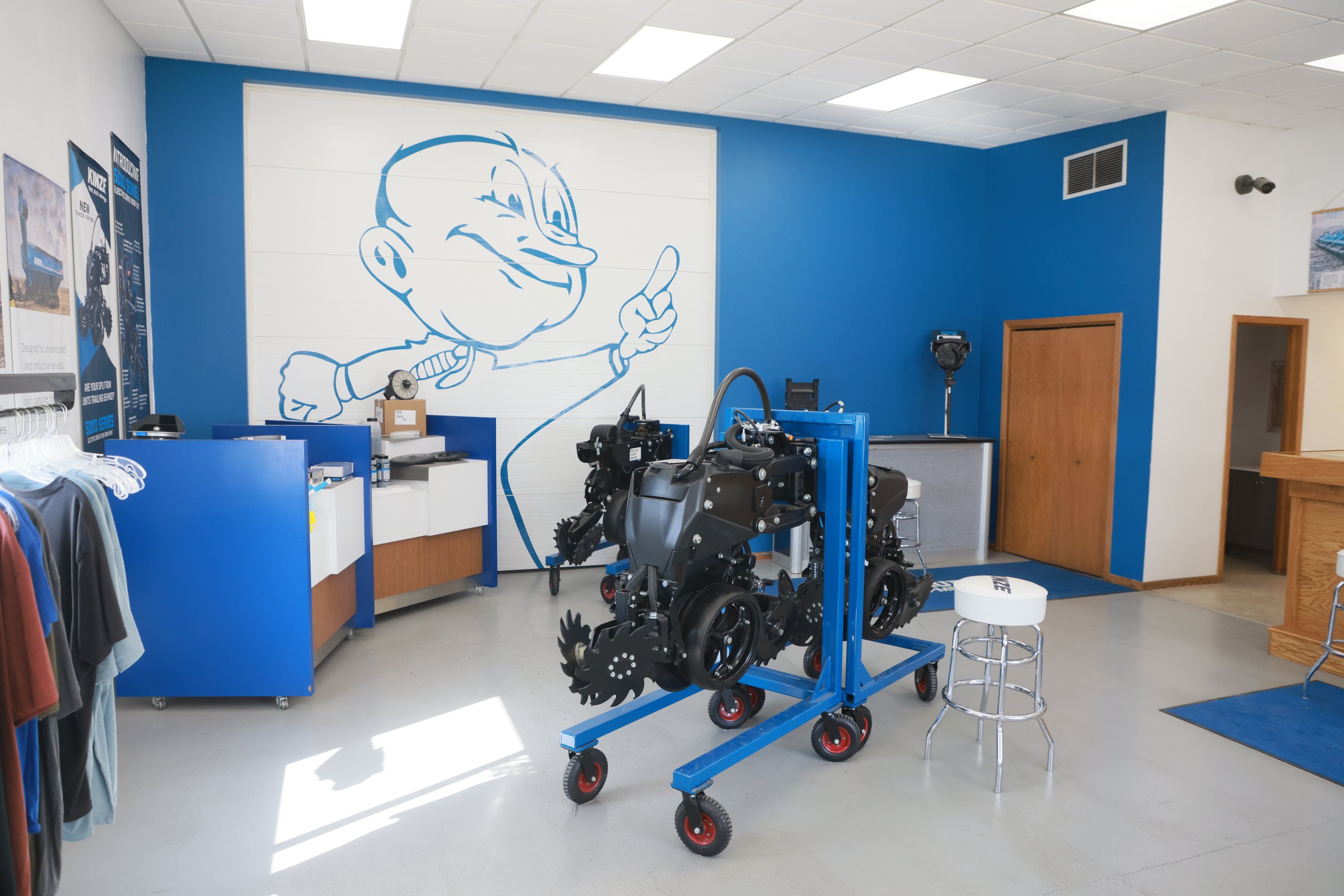 Inside the Blue Equipment store, with a Kinze row unit on display